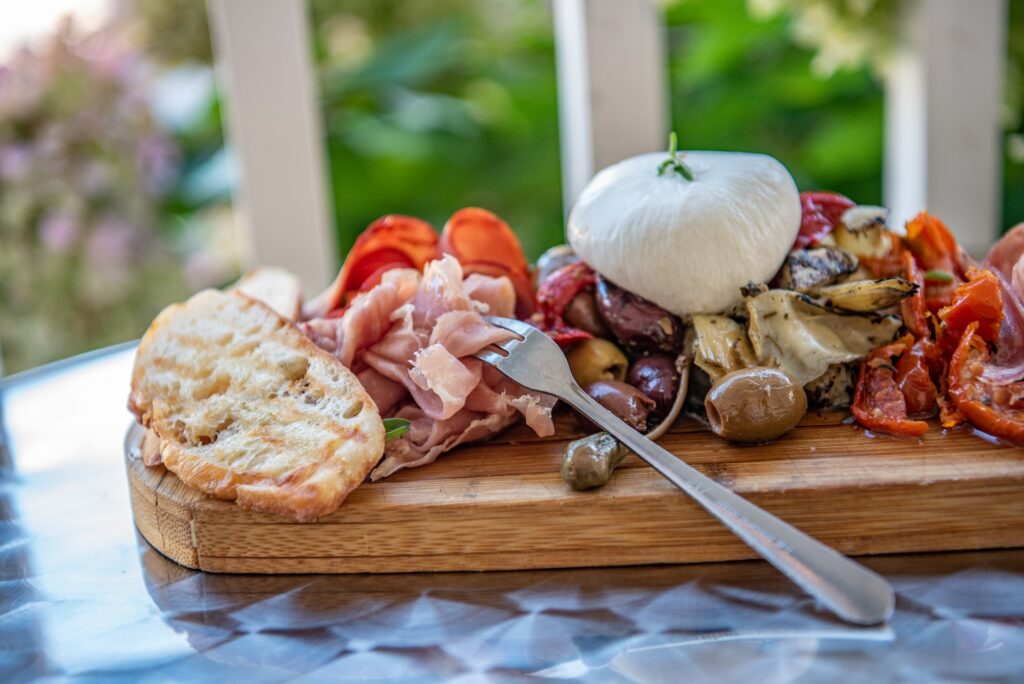 Beautifully prepared antipasti on a serving board.